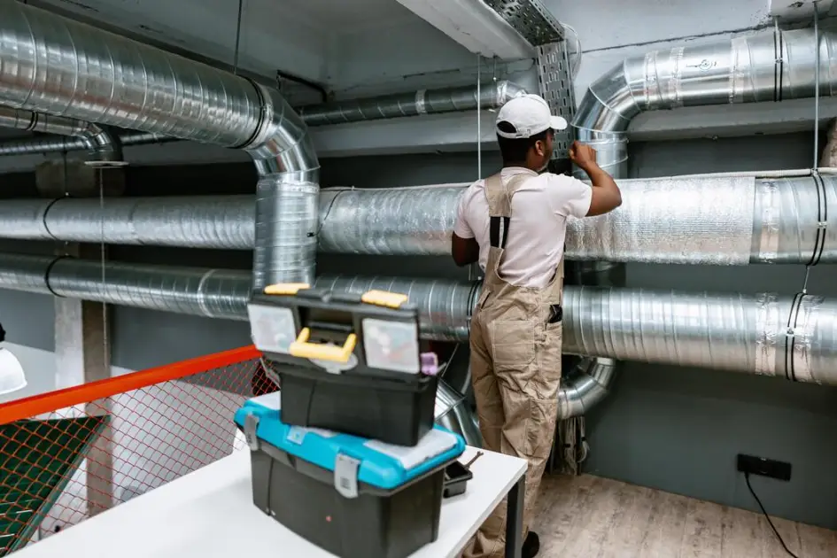 hvac-technician-installing-ductwork-in-a-modern-commercial-space-during-daylight-hours-photo